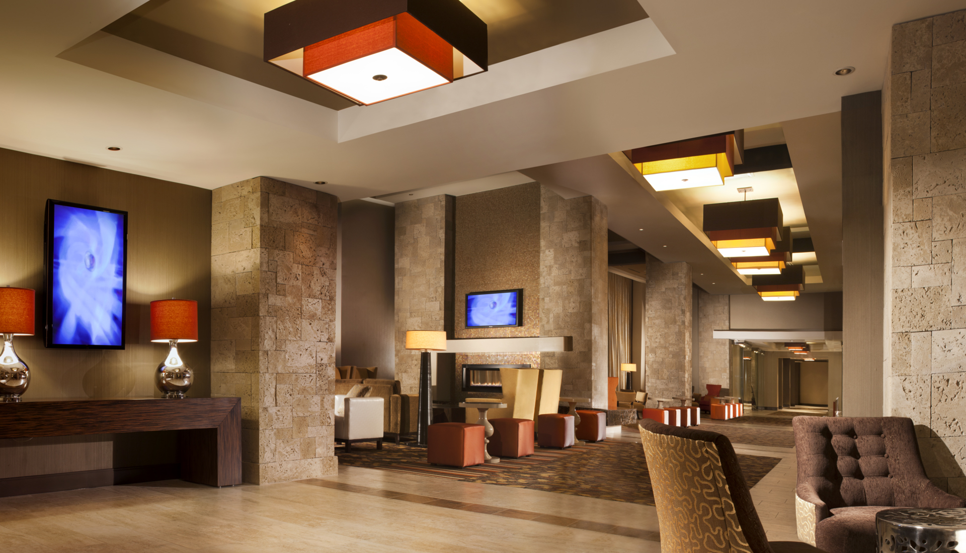 the lobby at coushatta casino and resort with brown and tan furniture and geometric lighting