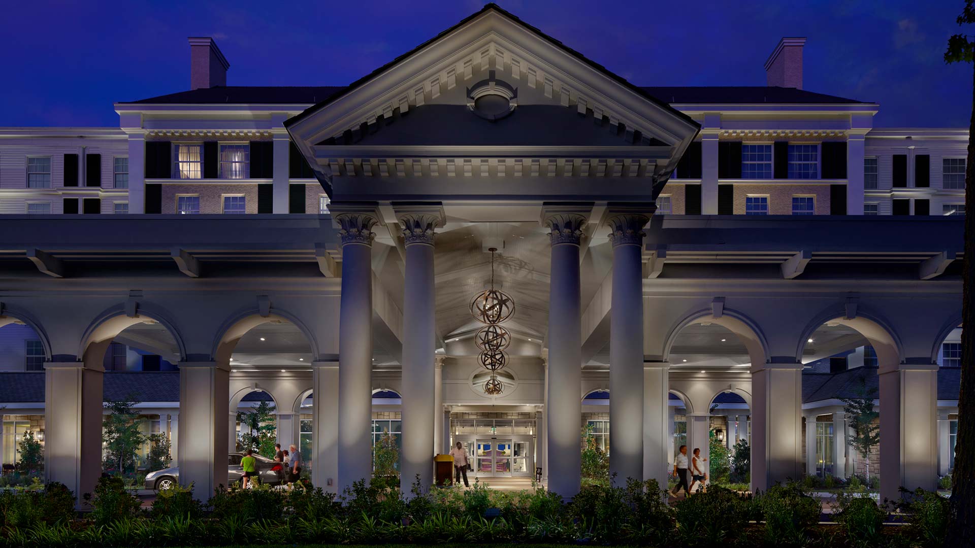 exterior of the guest house at graceland with large columns and arched architecture 